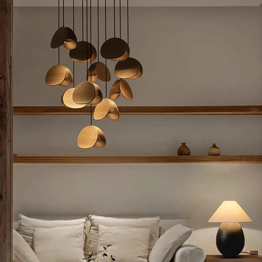 Modern living room with a chandelier, sofa, and side table.