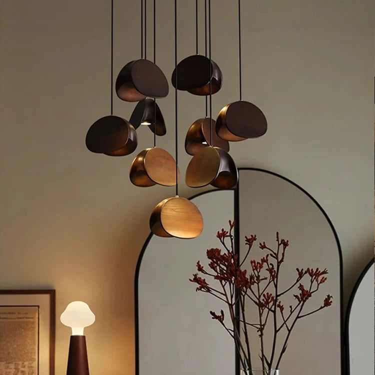 Modern chandelier hanging above a dining table with decor items.