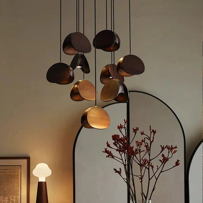 Modern chandelier hanging above a dining table with decor items.