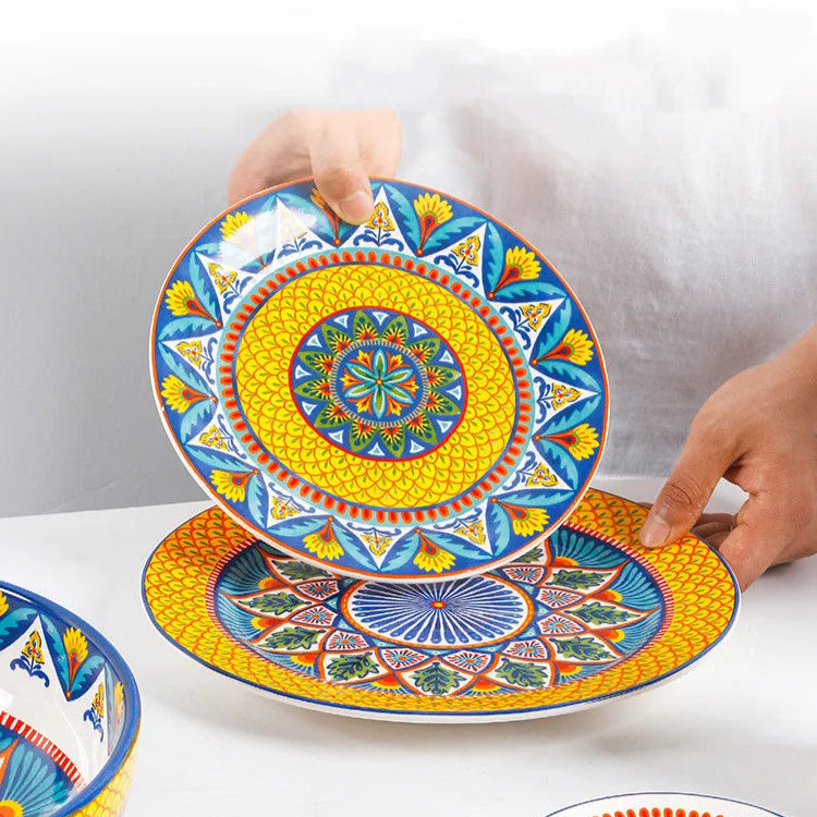 Colorful ceramic plates with intricate patterns held by a person on a white background
