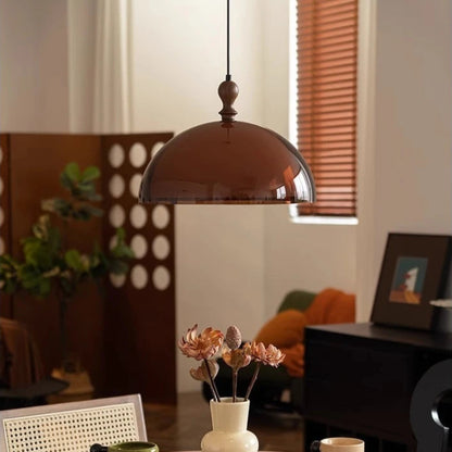 Dining room with a wooden table, pendant light, and decorative items.