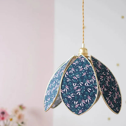 Decorative pendant light with floral pattern on a neutral background