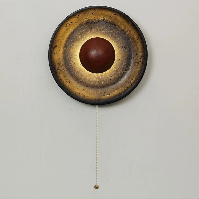 Decorative wall clock with a round design and brown center on a light gray background