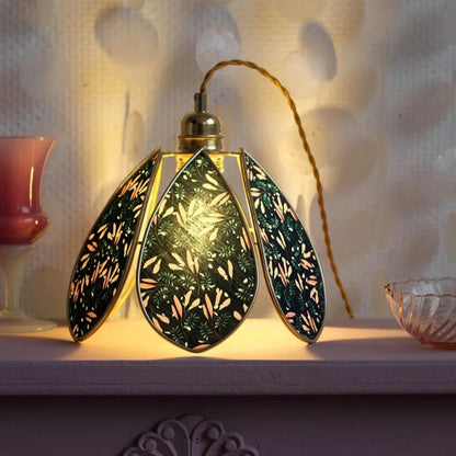 Decorative lamp with intricate design on a textured surface