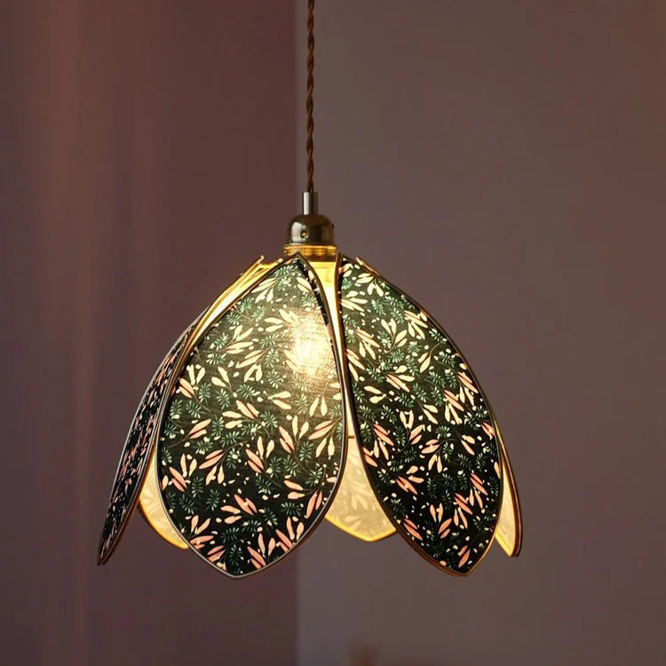 Decorative pendant light with floral design on a neutral background